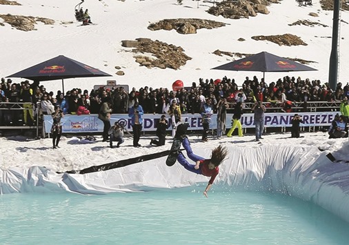 A Lebanese woman jumps into freezing water during a contest at the Lebanese ski resort of Kfardebian, northeast of Beirut.