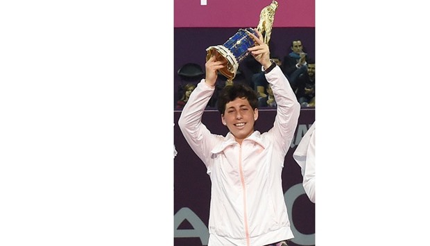 Carla Suarez Navarro holds up her trophy after winning the Qatar Total Open 2016 on Saturday.
