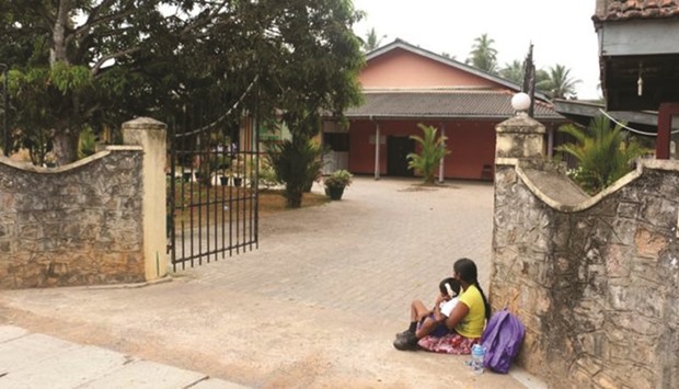 The six-year-old boy and his mother sitting near the gate of the school.