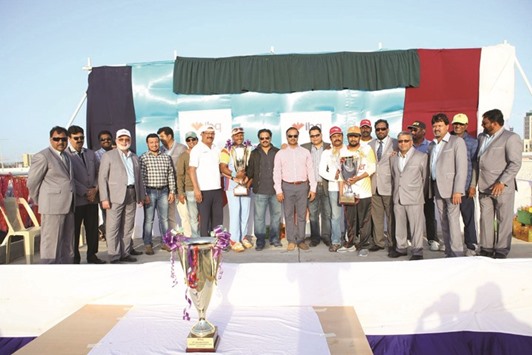 Chief guests IBQu2019s Electronic Banking manager Bacchu Nazareth and Financial Institutions assistant relationship manager Cedric and other officials pose with the captains of the winning team Doha Motors and runners-up Engineering Supplies after the IBQ Masters Cricket Tournament final.