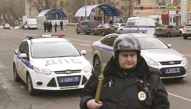 A police officer at the site where a woman suspected of murdering a young child was detained, near Oktyabrskoye Pole metro station in Moscow, Russia.