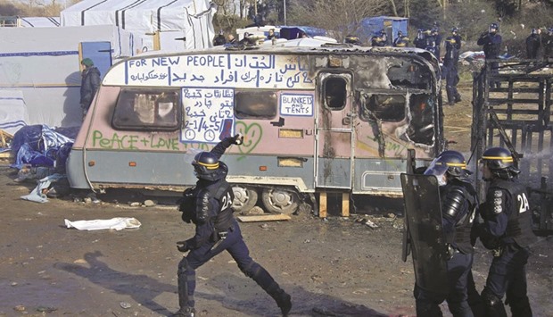 French riot policemen use tear gas in Calais.