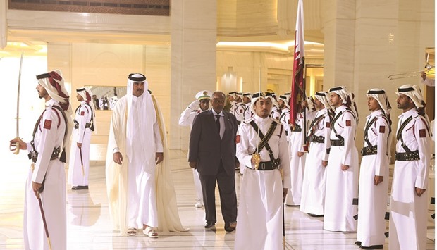 HH the Emir Sheikh Tamim bin Hamad al-Thani with Djibouti President Ismail Omar Guelleh during the official welcoming ceremony at the Emiri Diwan yesterday.