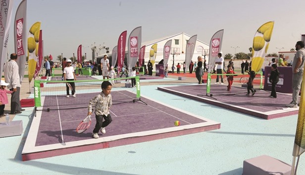 Children play tennis on National Sport Day last year.