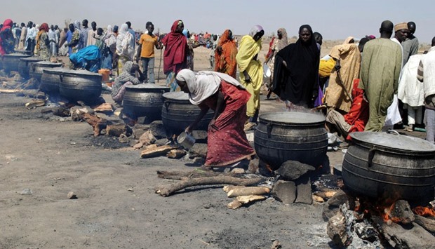 Women cook at an Internally Displaced Persons (IDP) camp at Dikwa, Borno State in north-eastern Nigeria. The National Emergency Management Agency in collaboration with Borno State Emergency Management Agency has set up new IDP camps in Ngala, Marte, Bama and Mafa councils to decongest the growing population of IDP camp at Dikwa.