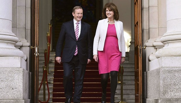Irelandu2019s Taoiseach Enda Kenny and Tanaiste Joan Burton depart the Government Buildings after announcing the beginning of the general election in Dublin, Ireland yesterday. The Taoiseach has dissolved the 31st Dail and the election date has been set for February 26.