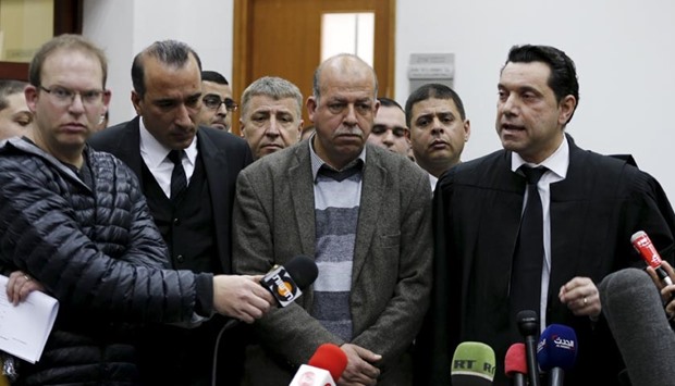 Hussein (C), father of Palestinian youth, Mohammed Abu Khudair speaks to the media after the sentencing of two of his son's murderers at the Jerusalem District Court in Jerusalem on Thursday.