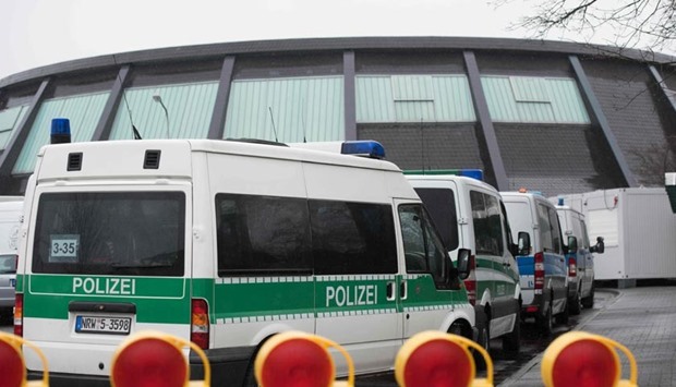 Police cars stand outside a refugee shelter in Attendorn on Thursday after a raid during which a suspect was arrested.