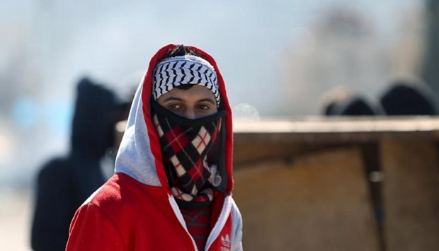 A Palestinian protester is seen during clashes with Israeli troops in the West Bank village of Qabatya near Jenin on Thursday.