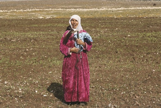 A farmer stands in a dry field in Bouskoura village near Casablanca.