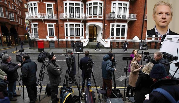 Members of the media wait opposite the Ecuadorian embassy in central London on Friday. Inset Julian Assange