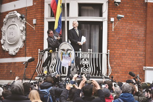 WikiLeaks founder Julian Assange addresses the media holding a printed report of the judgement of the UNu2019s Working Group on Arbitrary Detention on his case from the balcony of the Ecuadorian embassy in central London yesterday