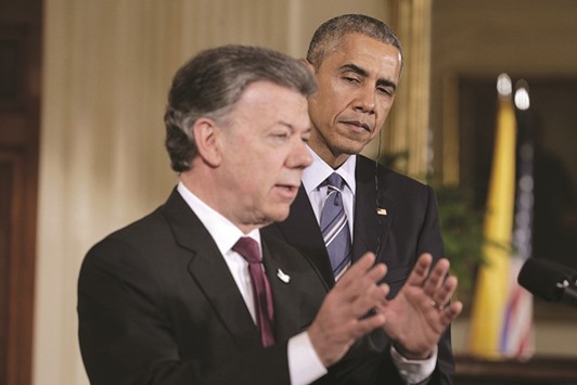 US President Barack Obama listens as President Juan Manuel Santos of Colombia speaks during a reception in the East Room of the White House in Washington yesterday.