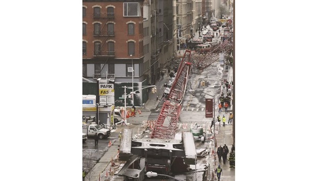 Emergency responders are seen at the scene of the crane collapse that stretched along nearly two city blocks in downtown Manhattan.