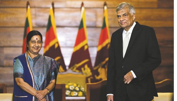 Sushma Swaraj, left, poses for a photograph with Ranil Wickremesinghe during their meeting in Colombo yesterday.