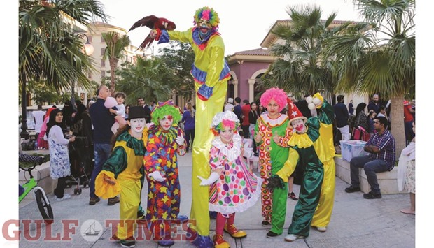 Stilt walkers and jugglers entertain spectators at the Pearl-Qataru2019s Medina Centrale.