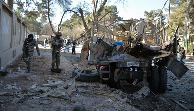 Pakistani paramilitary soldiers stand beside destroyed a security truck at the site of a bomb explosion that targeted a security convoy in Quetta. AFP