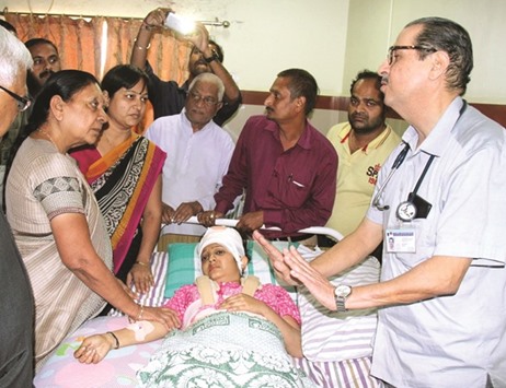 Gujarat Chief Minister Anandiben Patel speaks to a doctor as she visits a woman in a hospital who was injured after a Gujarat State Road Transport Corporation (GSRTC) bus fell off from a river bridge in South Gujaratu2019s Navsari district, in Ahmedabad yesterday.