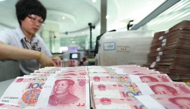 A teller counts yuan banknotes in a bank in Lianyungang, China. The currency has strengthened 0.4% in the past four weeks - the longest such run since October 2014 - after dropping 4.5% last year for its biggest annual retreat in more than two decades.
