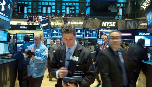 Traders work on the floor of the New York Stock Exchange. The willingness of US stock investors to abide price-earnings ratios stretching into three and four digits came under pressure on Friday as the Nasdaq Composite Index fell to its lowest since October 2014.