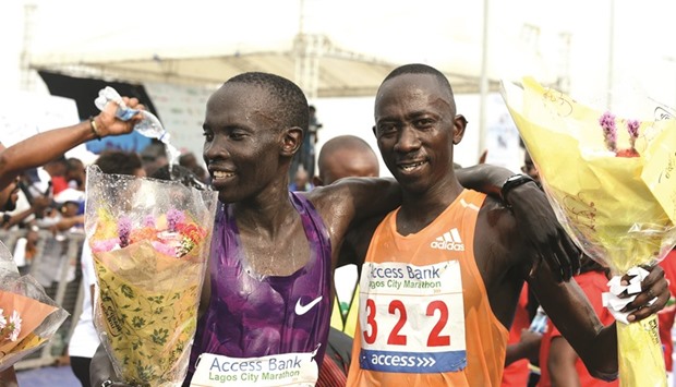 Marathon winner Kenyan Abraham Kipton (left) hugs compatriot and runner-up Hosea Kiptemboi at the end of the first Lagos City Marathon yesterday.