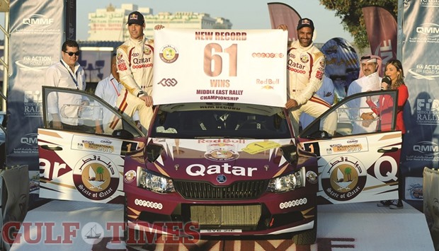 Nasser Saleh al-Attiyah (R) and co-driver Mathieu Baumel celebrate winning the Qatar International Rally yesterday.