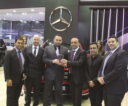 NBK officials at their pavilion at Qatar Motor Show 2016 receiving the award.