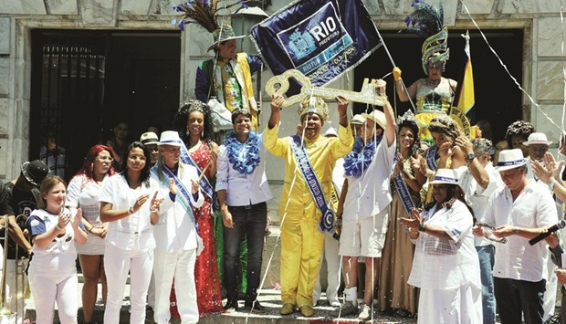 Carnival King Momo, Wilson Dias da Costa Neto receives the keys to the city from Rio mayor Eduardo Paes during the official launching ceremoney for the 2016 Carnival in Rio de Janeiro on Friday.