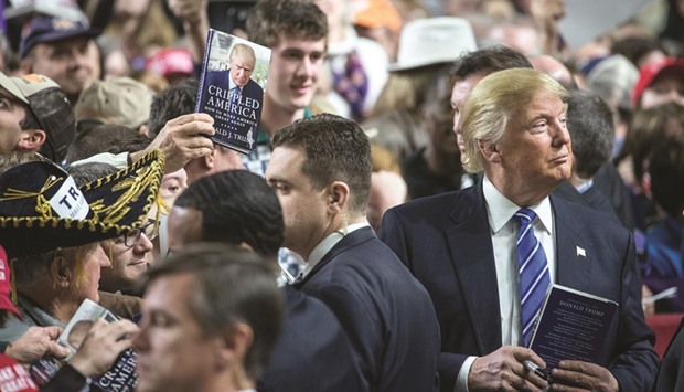 Donald Trump signs autographs at a campaign rally in Florence, South Carolina.