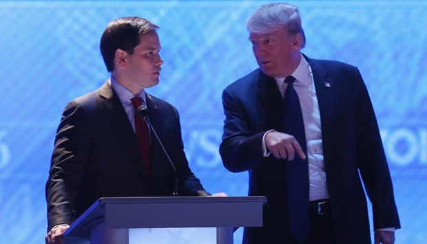 Marco Rubio (left) and Donald Trump talk during a commercial break in the Republican presidential debate at St. Anselm College in Manchester, New Hampshire on Saturday.