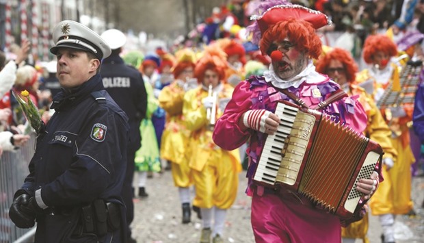 Masqueraded revellers celebrate Carnival Sunday in Cologne yesterday.