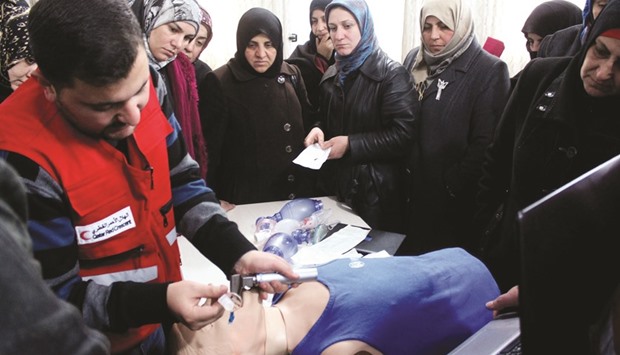 A trainer conducts a demonstration on neonatal resuscitation.
