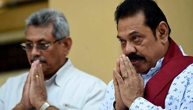 Mahinda Rajapakse and his brother Gotabhaya Rajapakse (left), who was the country's defence secretary in 2009, pray in Colombo on Monday as they join a petition against a UN-mandated investigation into alleged war crimes during the final stages of the islandu2019s Tamil separatist war.