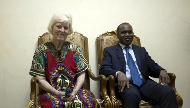 Freed hostage Jocelyn Elliott, who was kidnapped with her husband in Burkina Faso by a group affiliated to al Qaeda, sits with Burkina Faso's Foreign Minister Alpha Barry upon arrival in Ouagadougou on Monday.