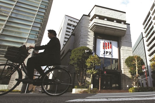 A man cycles past the Tokyo Stock Exchange. Since Japanese equities tumbled more than 20% from a peak last month, rallies have faltered amid a global selloff spurred by tumbling oil prices and concern about the outlook for the worldu2019s biggest economies.
