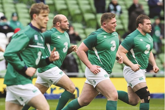 Irelandu2019s hooker Rory Best (2L) warms up with teammates.