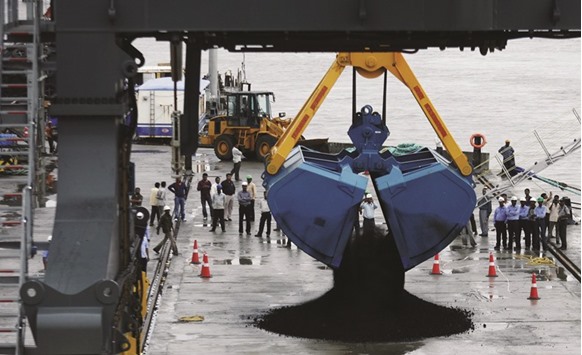 A crane unloads coal from a ship at Adani Cargo Port in Gujarat. Indiau2019s economic growth slowed in the last quarter of 2015, adding to pressure on Prime Minister Narendra Modiu2019s government to expedite stalled reforms in the next session of parliament when it presents its annual budget.