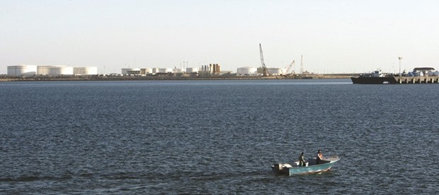 A speed boat passes by oil docks at the port of Kalantari in the city of Chabahar, east of the Strait of Hormuz in this January 17, 2012 file photo. Vitol expects that Iran will produce up to 500,000 bpd in additional oil by the middle of the year and another 200,000 bpd by year-end.
