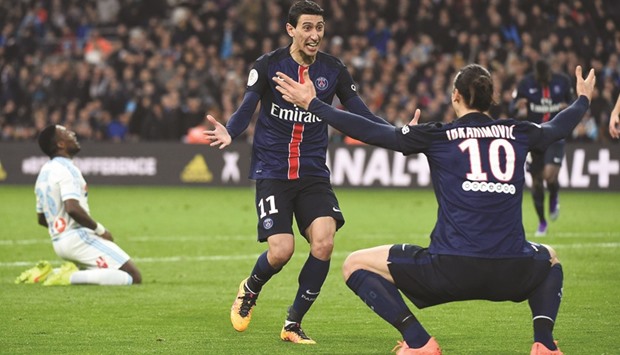 Paris Saint-Germain's Angel Di Maria celebrates with Zlatan Ibrahimovic after scoring the winning goal against Marseille during their French L1 match, in Marseille on Sunday. (AFP)