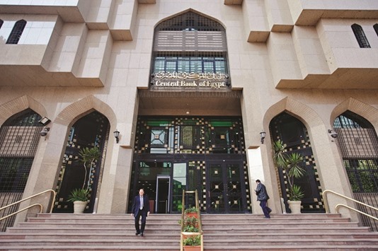 Pedestrians use the stairs outside of Egyptu2019s central bank in Cairo. The bank has defended the pound against growing pressure to devalue, but with foreign exchange reserves scarcely enough to finance more than three months worth of imports, economists say it cannot hold out forever.