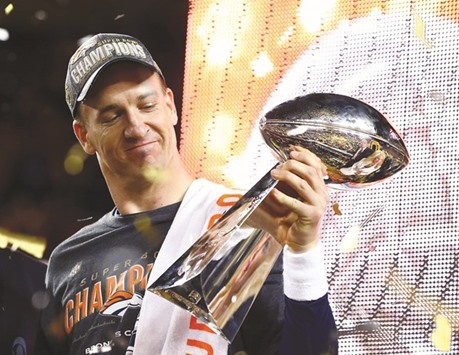 Broncos quarterback Peyton Manning hoists the Vince Lombardi Trophy after defeating the Panthers in Super Bowl 50.