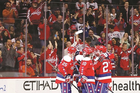 Washington Capitals players celebrate after scoring the go-ahead goal against the Philadelphia Flyers in the third period.