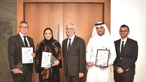 Al Khaliji officials with the accolades from the u201cBanker Middle East Qatar Product Awards 2015.u201d