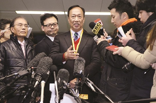 Terry Gou (centre), founder and chairman of Taiwanu2019s Foxconn, speaks to reporters after a meeting with Sharp executives in Osaka. He said his company has become the preferred bidder, with a final agreement expected by the end of the month.