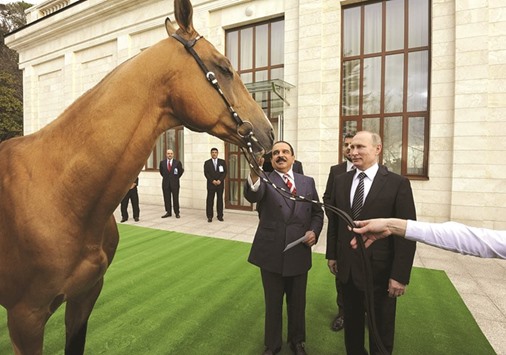 As symbols of their friendship, Russian President Vladimir Putin presents an Akhal-Teke horse to Bahrainu2019s King Hamad bin Isa al-Khalifah at the Bocharov Ruchei state residence in Sochi, Russia, yesterday. King Hamad awarded Putin a sword made of Damascus steel. Russia and Bahrain are planning to increase economic ties, including Russian food exports to Bahrain and co-operation involving Russian state natural gas company Gazprom.