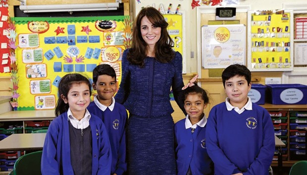 Catherine, Duchess of Cambridge, poses with children from the Salusbury primary school in Queenu2019s Park, London, during the filming for Childrenu2019s Mental Health Week.