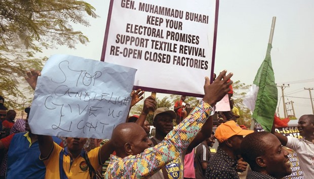 Protestors hold placards during a demonstration in Lagos yesterday over the 45% hike in electricity prices.