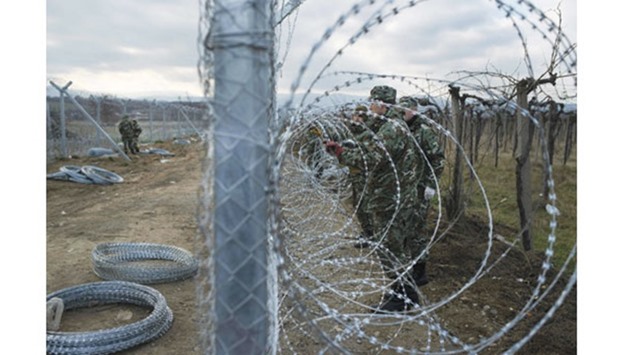 Macedonian soldiers build a second border fence in the Greek-Macedonian border near Gevgelija.