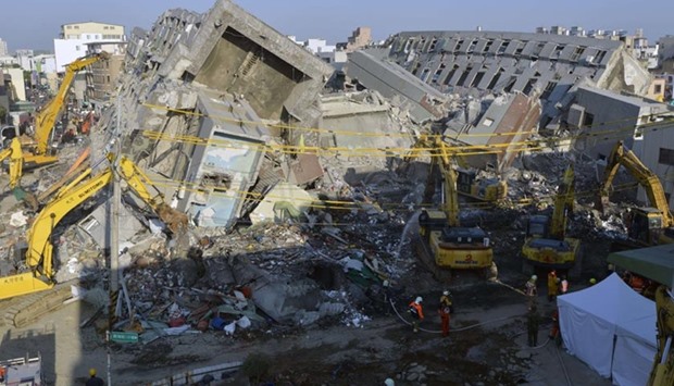 Heavy cranes knock down the collapsed Wei-Kuan complex in Tainan on Tuesday.