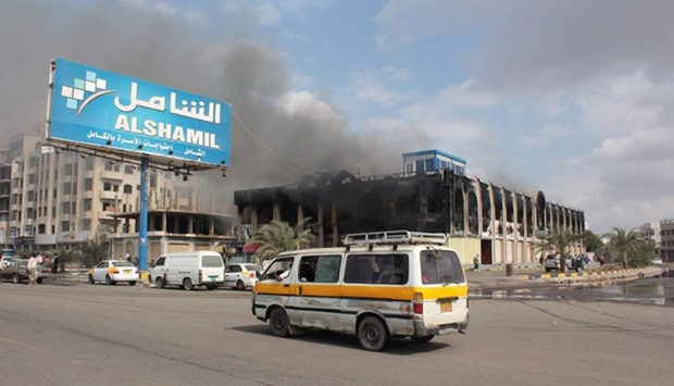 A vehicle drives past the Shamel shopping centre in the Mansura suburb of Aden on Tuesday in the aftermath of clashes between forces loyal to President Abedrabbo Mansour Hadi and al-Qaeda members.